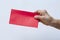 Senior woman right hand holding red envelope in  white background, Close up shot, Happy new year chinese concept