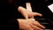 Senior woman`s hands playing piano. Close up side view of elderly hands and fingers playing a song.