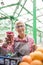 Senior woman sells raspberries on market
