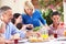 Senior Woman Serving A Family Meal