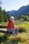 Senior woman sitting on a bench in Switzerland