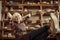 Senior woman sitting on chair with legs on table against shelves with pottery goods