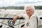 Senior woman sitting at edge of niagara falls