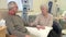 Senior Woman Sitting With Husband During Chemotherapy Treatment