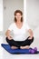 Senior woman sitting in lotus position