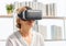 Senior woman sitting on the sofa having fun with virtual reality glasses, Happy elderly technology concepts