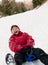 Senior woman on sledge - winter snow activity