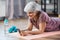 senior woman with smartphone exercising at home