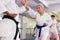 Senior woman sparring during group karate training