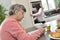 Senior woman spending time doing crosswords with a home helper in the background