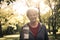 Senior woman in sports clothing standing in park looking