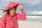 Senior woman and stormy weather at beach