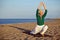 Senior woman stretching on the beach