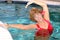 Senior woman stretching in the pool