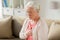 Senior woman suffering from heartache at home