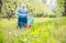 Senior woman supported by great grandson walking in orchard