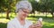 Senior woman taking selfies at the park