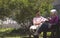 Senior woman talking with doctor outside on nursing home bench