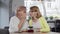 Senior woman talking quietly to her mature daughter at the cafe