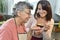 Senior woman tasting what home carer cookied