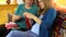 Senior woman teach granddaughter girl how to knit. Zoom out