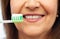 Senior woman with toothbrush brushing her teeth