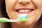 Senior woman with toothbrush brushing her teeth