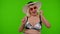 Senior woman tourist in sunglasses, looking at camera, dancing, celebrating on chroma key background