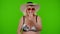 Senior woman tourist in swimsuit bra wearing red sunglasses, waving hands hi hello welcome greetings