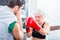 Senior woman with trainer in boxing sparring