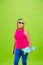 Senior woman in ultra trendy attire isolated on bright green background