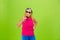 Senior woman in ultra trendy attire isolated on bright green background