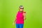 Senior woman in ultra trendy attire isolated on bright green background