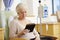 Senior Woman Undergoing Chemotherapy With Digital Tablet