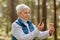 Senior woman using smartphone to identify mushroom