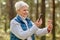 Senior woman using smartphone to identify mushroom