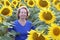 Senior woman in vibrant sunflower field