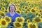 Senior woman in vibrant sunflower field