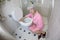 Senior woman vomiting in the bathroom.