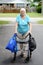 Senior woman and walker overloaded with shopping bags