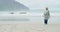 Senior woman walking on beach