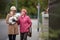 Senior woman walking her little dog with her granddaughter