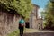 Senior woman walking hiking along the path of the historic pilgrimage route from Sacred Mount or Sacro Monte of Varese, Italy