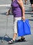 Senior woman walks on the street with a walker