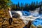 Senior woman watching the Murtle River as it tumbles over the cusp of Dawson Falls in Wells Gray Provincial Park