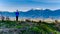 Senior Woman watching the sun setting over Cheam Peak, Lady Peak and Knight Peak in the Cascade Mountains