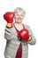 Senior woman wearing boxing gloves smiling