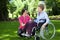 Senior woman on wheelchair with caring caregiver