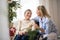 A senior woman in wheelchair with a health visitor at home at Christmas time.