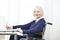 Senior woman in wheelchair on a table